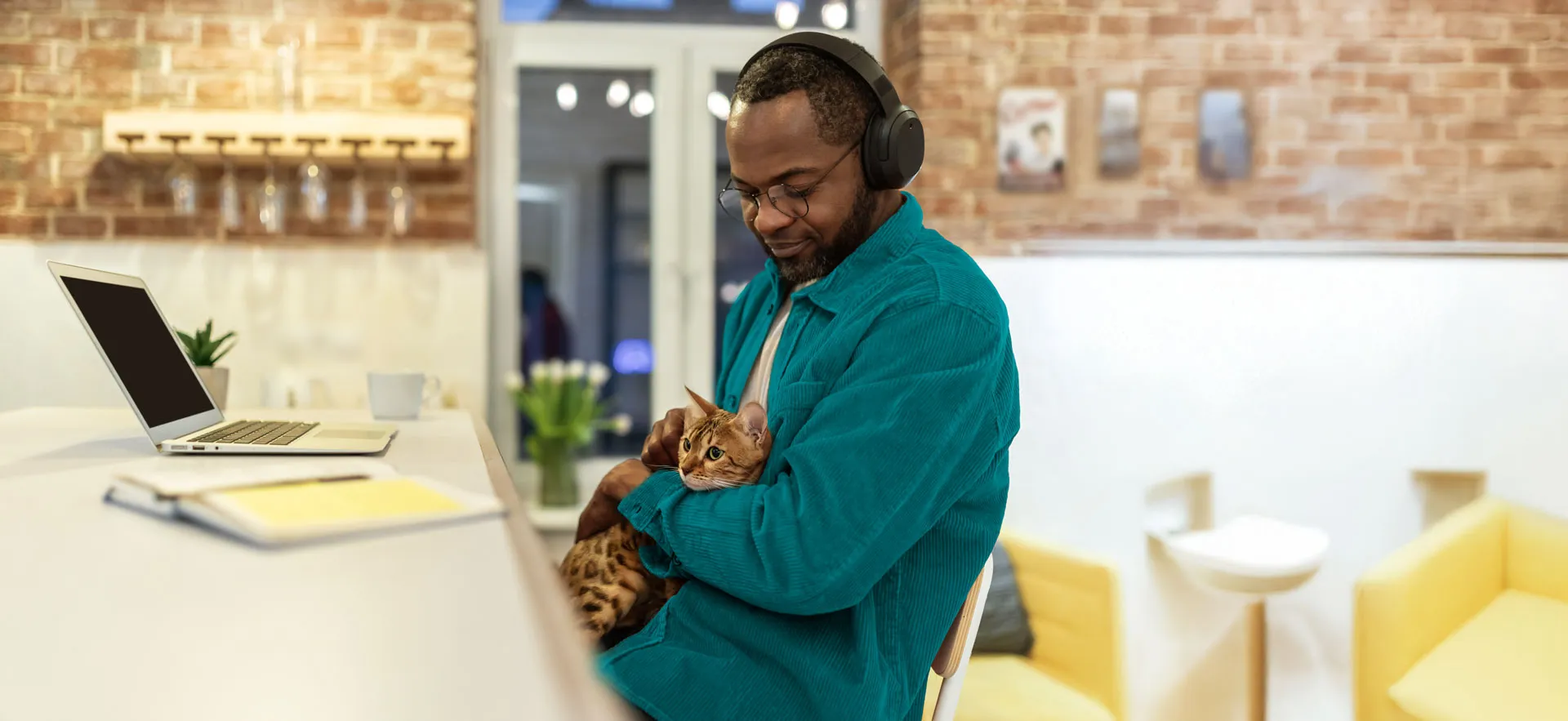 A man sits in his office with his cat
